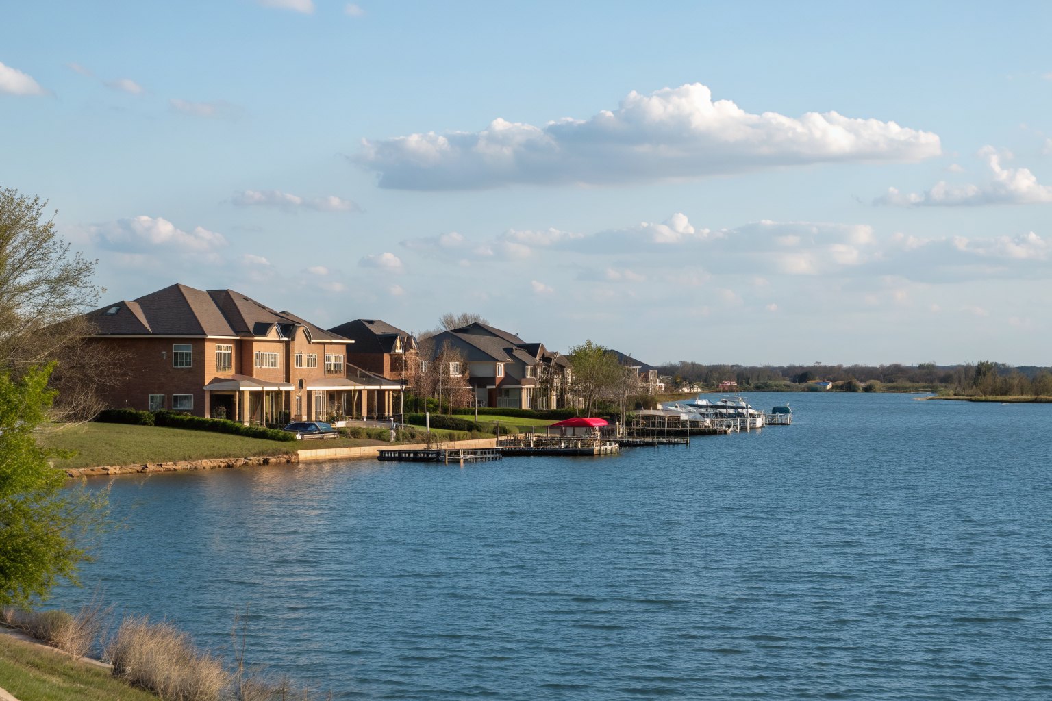Lake shoreline lined with brick homes and boat docks